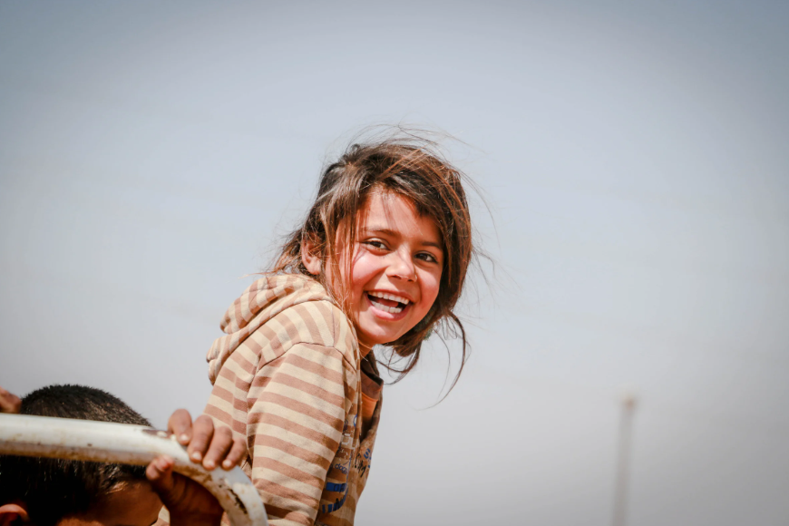 A Young Girl Refugee with a Cheerful Smile